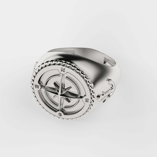 Elegant silver compass ring with anchor design, representing adventure and direction.